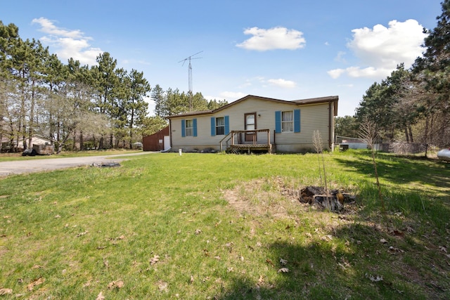 manufactured / mobile home with a garage, driveway, and a front yard
