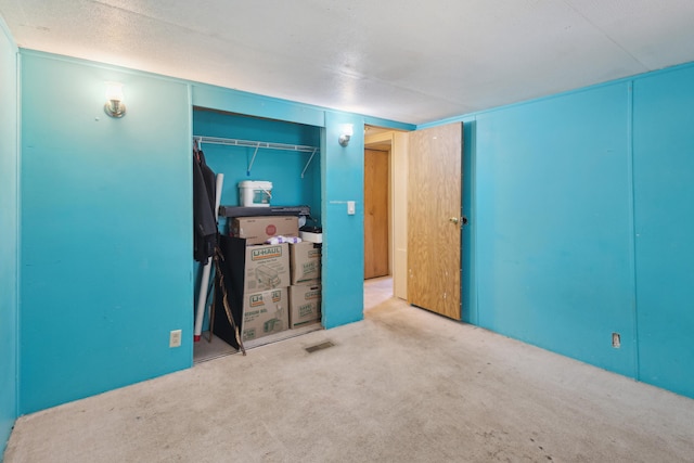 unfurnished bedroom featuring carpet floors and a closet