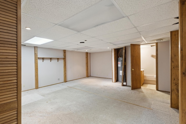 finished below grade area with carpet floors, recessed lighting, a drop ceiling, and electric water heater