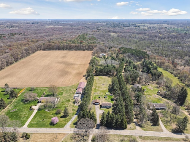 aerial view featuring a view of trees and a rural view
