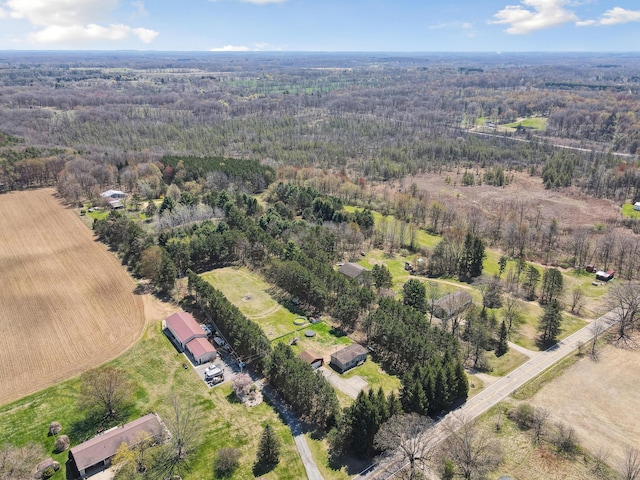 aerial view featuring a view of trees and a rural view