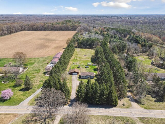 birds eye view of property featuring a view of trees and a rural view