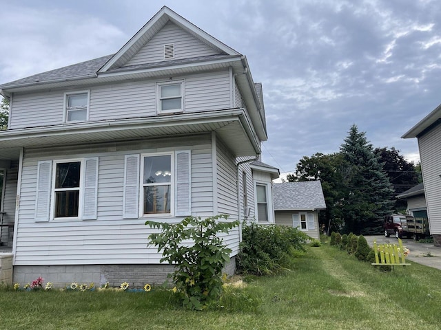 view of side of home featuring a lawn