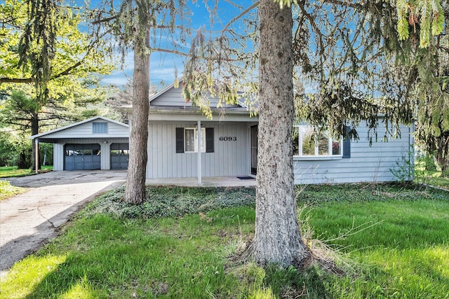6093 Porter Rd, Grand Blanc, MI 48439 - single story home with an outbuilding, concrete driveway, and covered porch