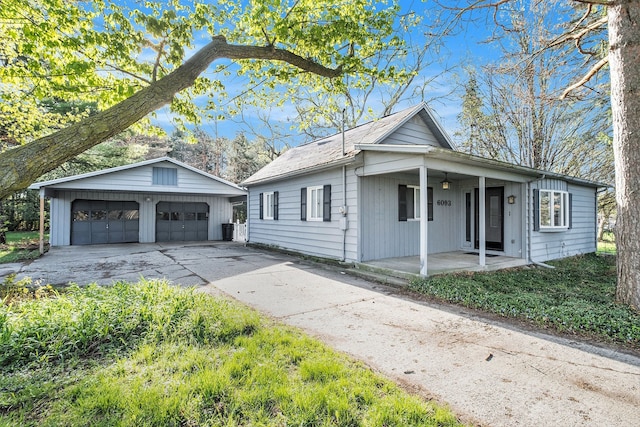 6093 Porter Rd, Grand Blanc, MI 48439 - view of front facade featuring covered porch, a ceiling fan, an outdoor structure, and a garage