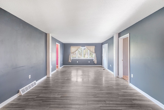 6093 Porter Rd, Grand Blanc, MI 48439 - interior space featuring baseboards, visible vents, and dark wood-style floors