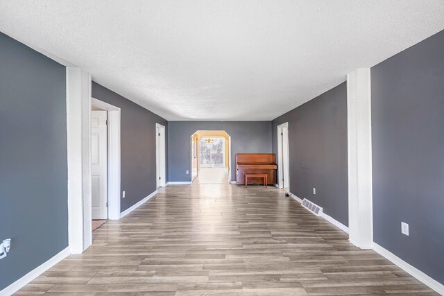 6093 Porter Rd, Grand Blanc, MI 48439 - interior space with arched walkways, baseboards, visible vents, and wood finished floors