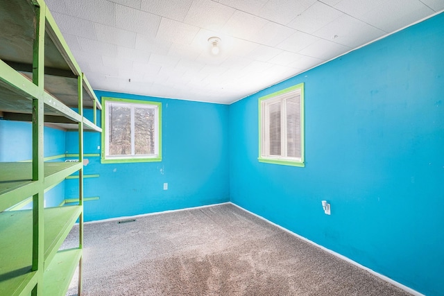 6093 Porter Rd, Grand Blanc, MI 48439 - unfurnished bedroom featuring baseboards, visible vents, and carpet
