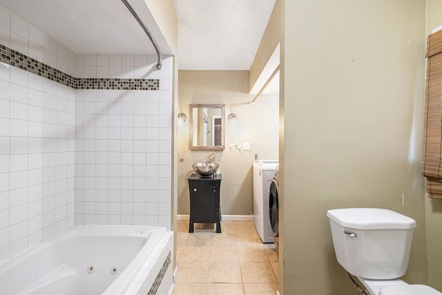 6093 Porter Rd, Grand Blanc, MI 48439 - bathroom featuring tile patterned flooring, a combined bath / shower with jetted tub, toilet, and independent washer and dryer