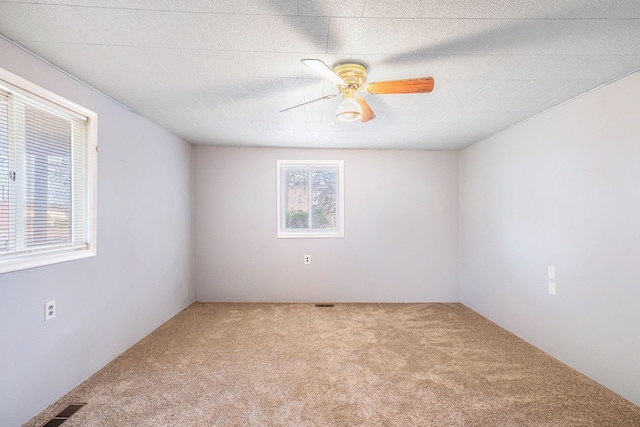 6093 Porter Rd, Grand Blanc, MI 48439 - carpeted spare room featuring a ceiling fan, visible vents, and plenty of natural light
