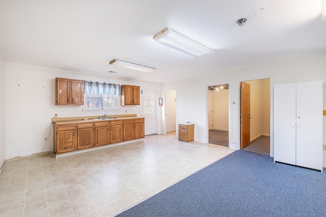 6093 Porter Rd, Grand Blanc, MI 48439 - kitchen featuring light countertops, a sink, and brown cabinets