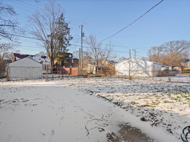 snowy yard with fence