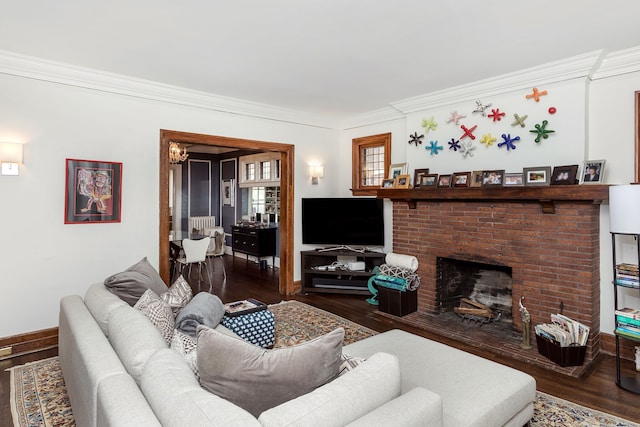 living area featuring crown molding, baseboards, wood finished floors, and a fireplace