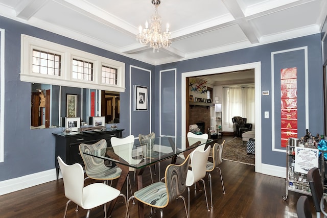 dining room with dark wood-style flooring, a fireplace, beam ceiling, a chandelier, and coffered ceiling