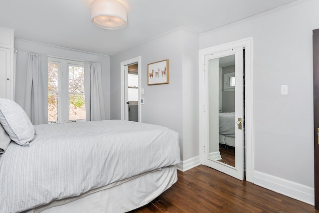 bedroom featuring baseboards, crown molding, and wood finished floors