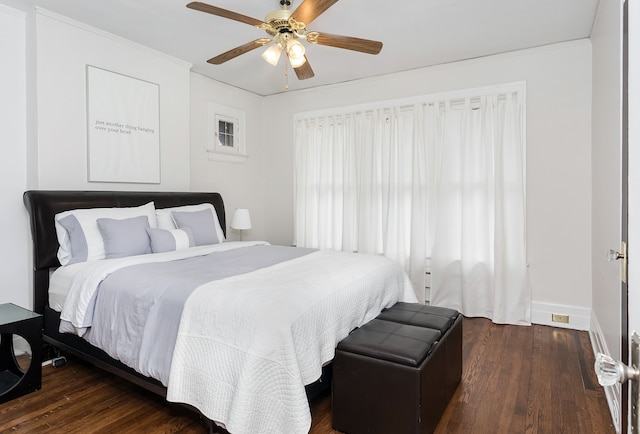 bedroom with baseboards, ornamental molding, a ceiling fan, and dark wood finished floors