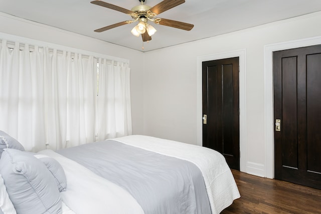 bedroom featuring a ceiling fan and dark wood finished floors