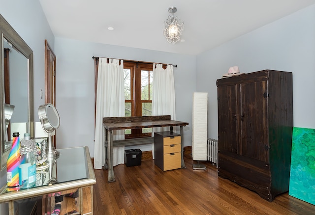 office area with radiator, wood finished floors, and a notable chandelier