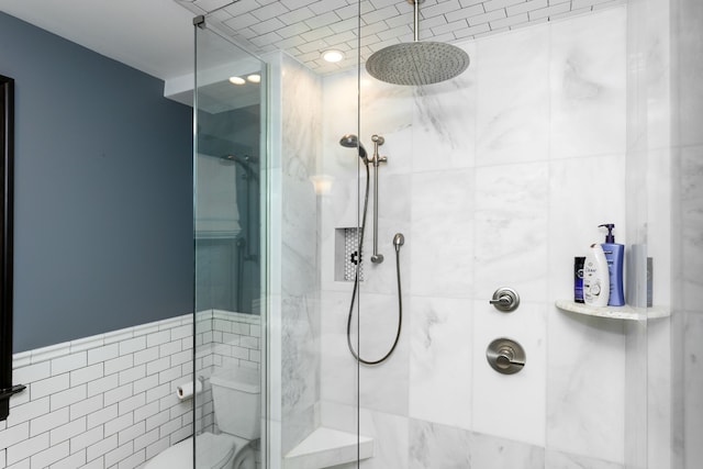 full bath with a stall shower and toilet
