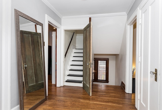 foyer entrance featuring crown molding, dark wood finished floors, baseboards, and stairway