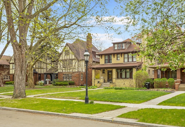 view of front of home with a front lawn and brick siding
