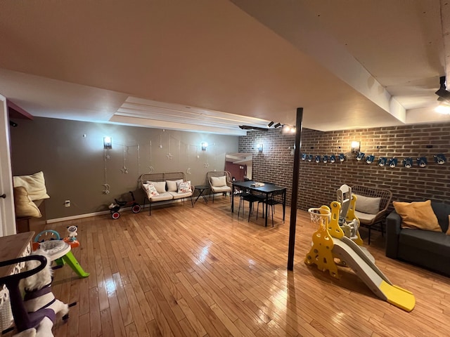 6367 Sheppard Dr, Westland, MI 48185 - game room featuring baseboards, hardwood / wood-style floors, and brick wall