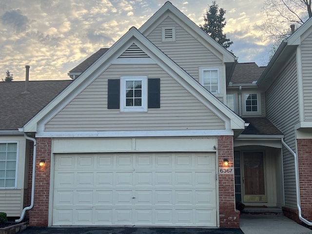 6367 Sheppard Dr, Westland, MI 48185 - view of front of property featuring roof with shingles, brick siding, and driveway