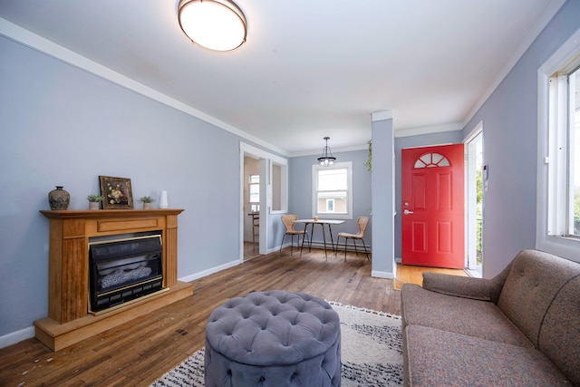 137 W Sheffield Ave, Pontiac, MI 48340 - living room featuring baseboards, a baseboard heating unit, ornamental molding, a glass covered fireplace, and wood finished floors