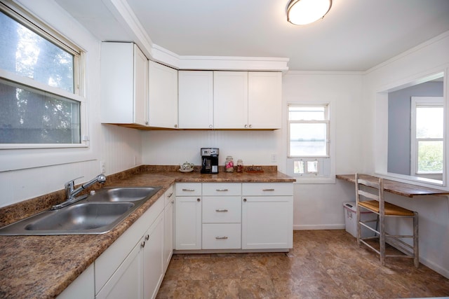 137 W Sheffield Ave, Pontiac, MI 48340 - kitchen featuring a sink, ornamental molding, white cabinetry, and a healthy amount of sunlight