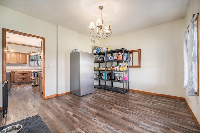 unfurnished dining area with dark wood-style flooring, baseboards, a chandelier, and visible vents