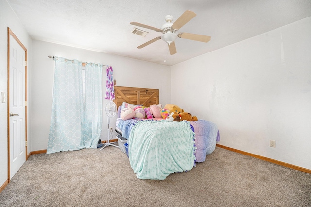 carpeted bedroom with baseboards, a ceiling fan, and visible vents