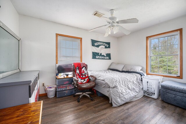 bedroom featuring visible vents, ceiling fan, and wood finished floors