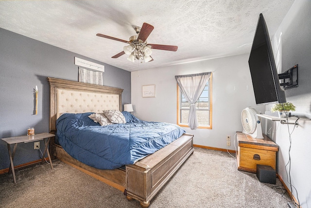 bedroom with baseboards, carpet flooring, a textured ceiling, and a ceiling fan