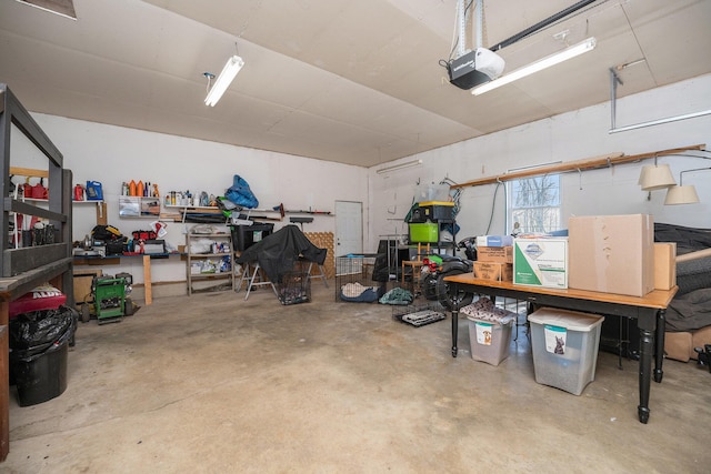 garage with a garage door opener and a workshop area