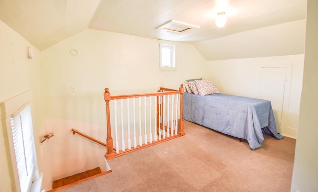 carpeted bedroom with lofted ceiling