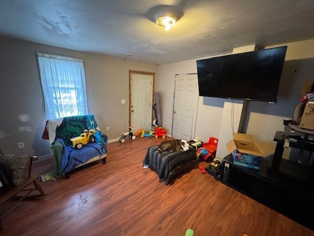 bedroom with baseboards and wood finished floors