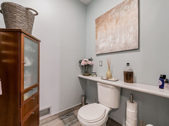 17477 Iris Cir, Clinton Township, MI 48036 - bathroom featuring baseboards, toilet, and wood finished floors