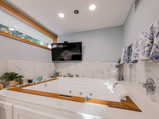 17477 Iris Cir, Clinton Township, MI 48036 - bathroom featuring backsplash, a tub with jets, and recessed lighting