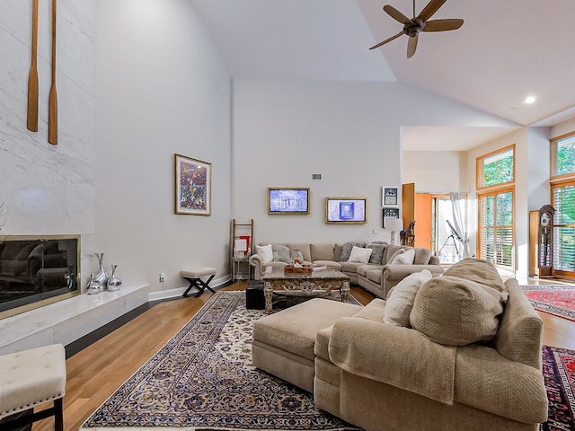 17477 Iris Cir, Clinton Township, MI 48036 - living room with high vaulted ceiling, wood finished floors, a ceiling fan, a high end fireplace, and baseboards