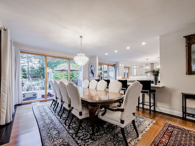 17477 Iris Cir, Clinton Township, MI 48036 - dining space with a chandelier, wood finished floors, recessed lighting, baseboards, and decorative columns