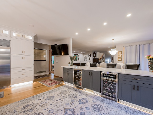 17477 Iris Cir, Clinton Township, MI 48036 - kitchen featuring beverage cooler, stainless steel built in refrigerator, light wood-type flooring, a chandelier, and recessed lighting