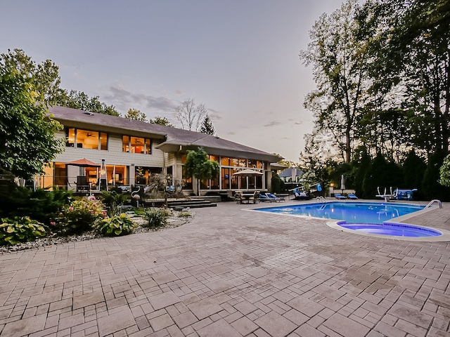 17477 Iris Cir, Clinton Township, MI 48036 - pool at dusk featuring a patio area and an outdoor pool