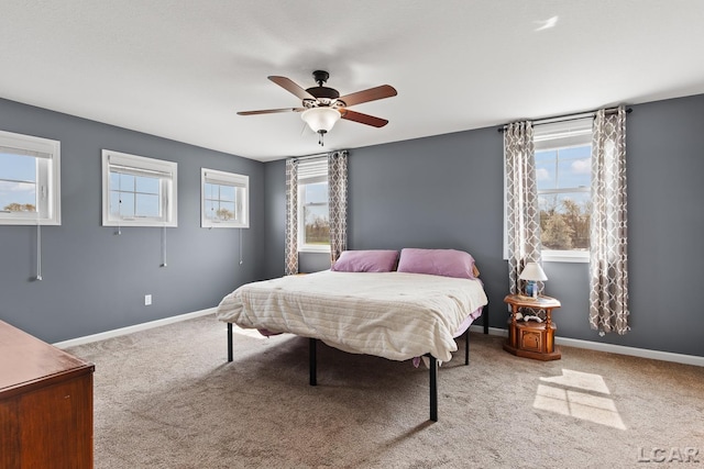 carpeted bedroom with baseboards and ceiling fan