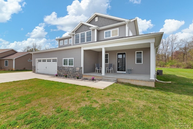 craftsman inspired home featuring a garage, a front lawn, central AC unit, concrete driveway, and a porch