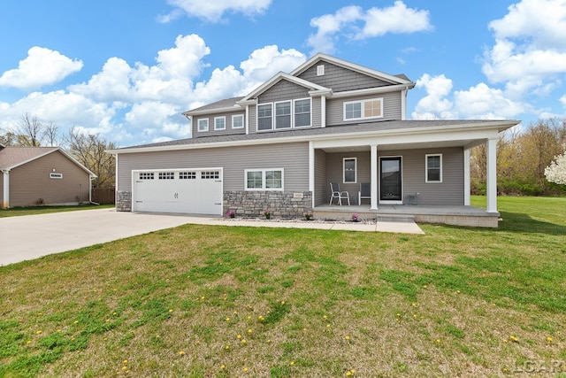 craftsman house with a porch, stone siding, a front yard, and concrete driveway