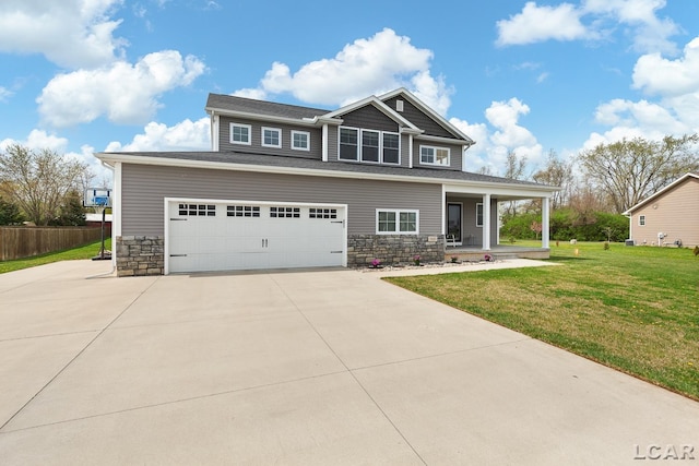 craftsman-style home featuring fence, a front lawn, stone siding, concrete driveway, and covered porch