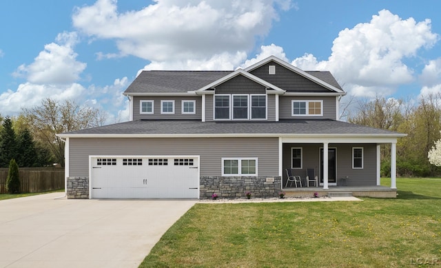 craftsman house with stone siding, a porch, driveway, and a front yard