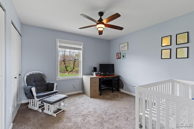 bedroom with ceiling fan, a crib, carpet, baseboards, and a closet