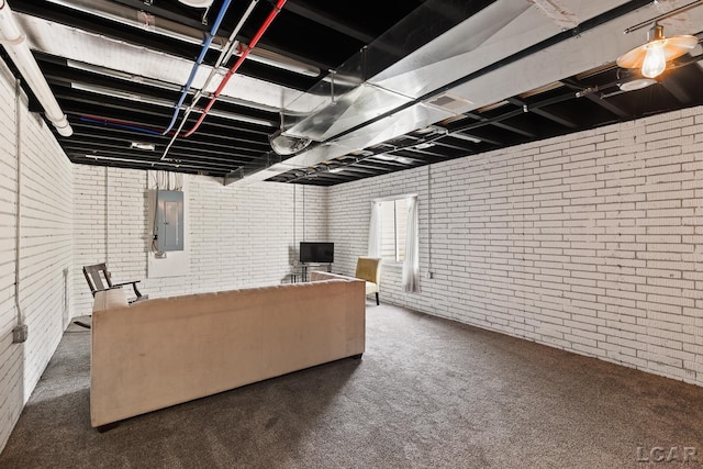 carpeted living room with electric panel, brick wall, and visible vents