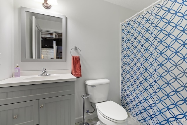 bathroom with vanity, toilet, and curtained shower